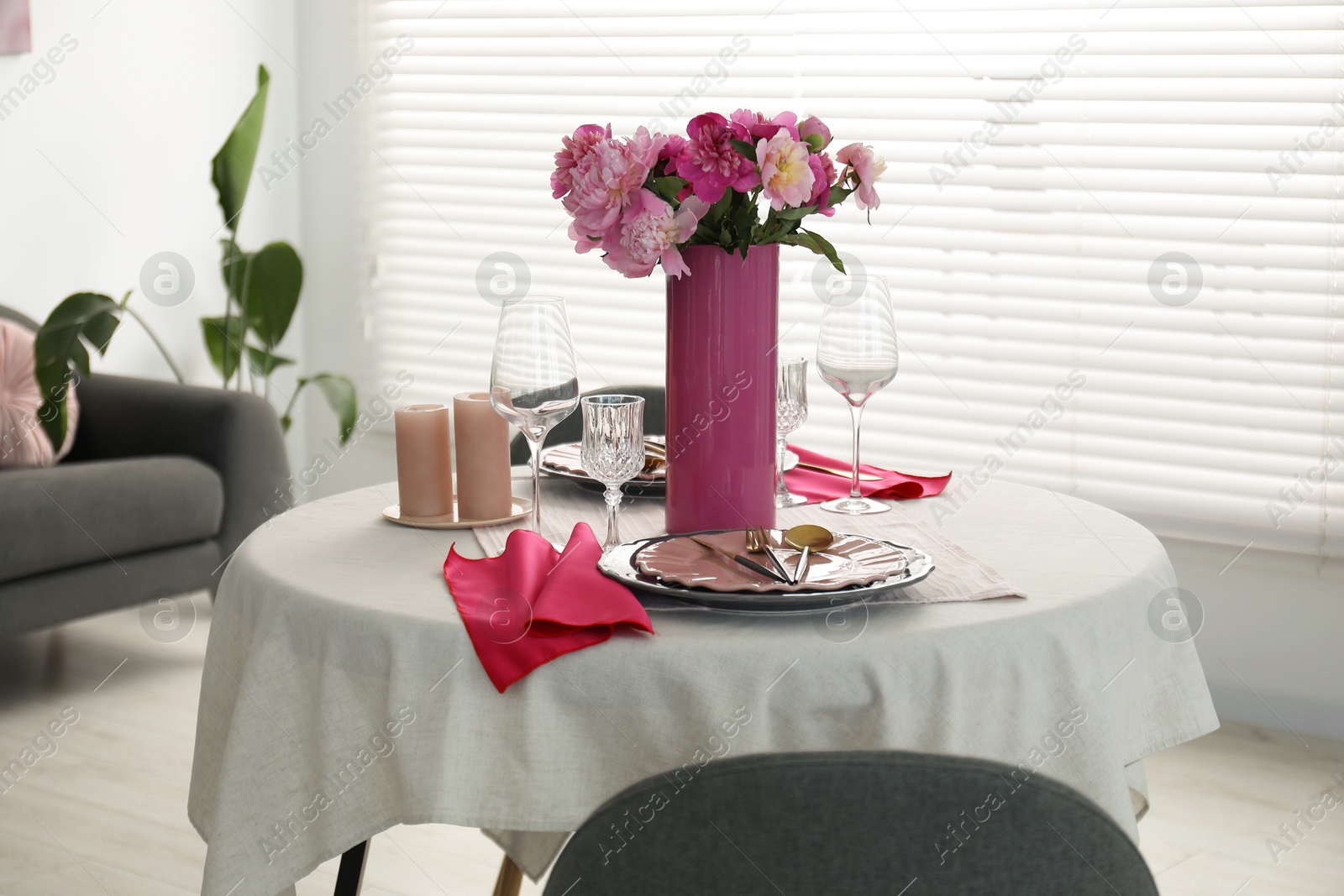 Photo of Beautiful table setting with pink peonies and candles