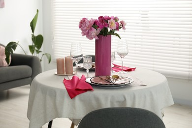 Photo of Beautiful table setting with pink peonies and candles