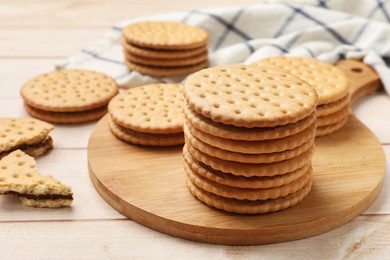 Photo of Fresh tasty sandwich cookies on wooden table, closeup