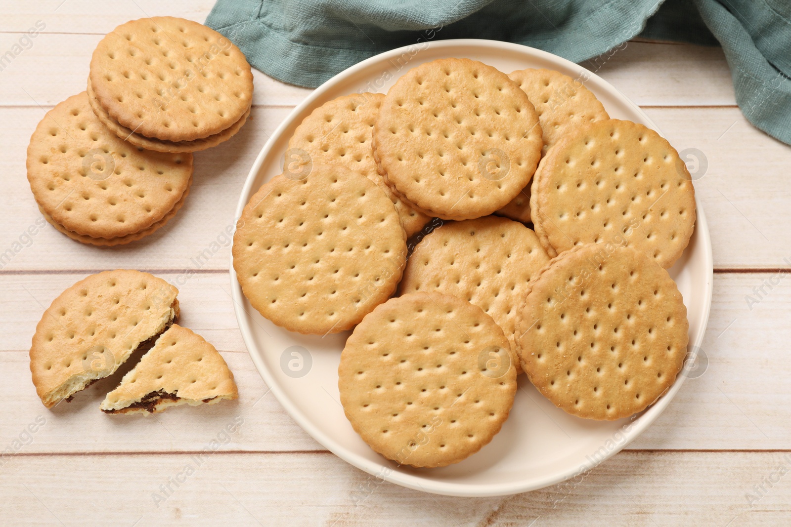 Photo of Fresh tasty sandwich cookies on wooden table, top view