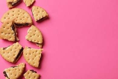 Tasty sandwich cookies on pink background, top view. Space for text