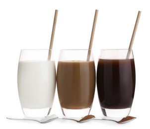 Delicious protein shakes in glasses and spoons with powder isolated on white