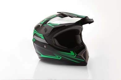 Photo of New stylish motorcycle helmet on white background