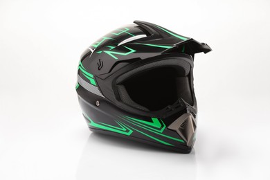 Photo of New stylish motorcycle helmet on white background