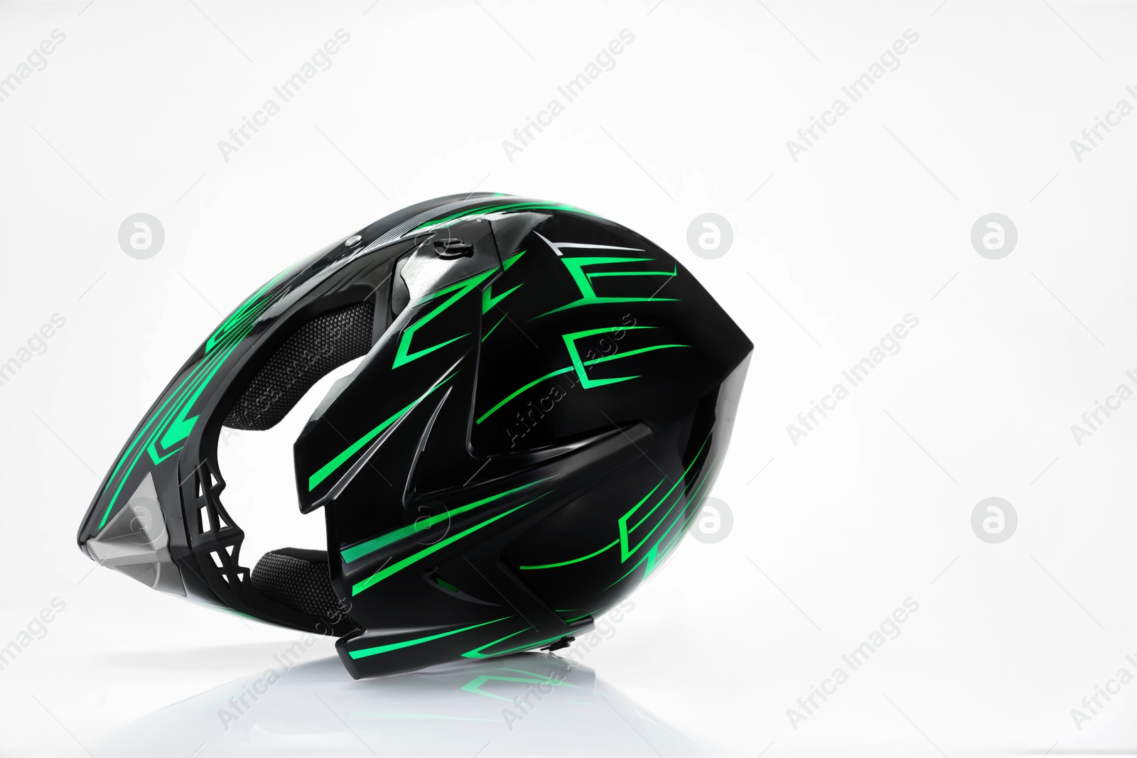 Photo of New stylish motorcycle helmet on white background, space for text