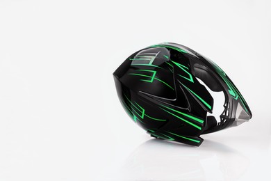 Photo of New stylish motorcycle helmet on white background, space for text