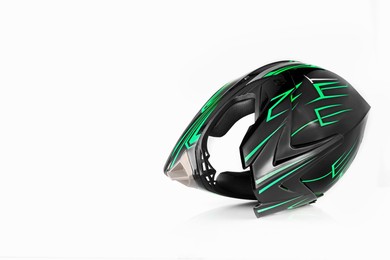 Photo of New stylish motorcycle helmet on white background, space for text