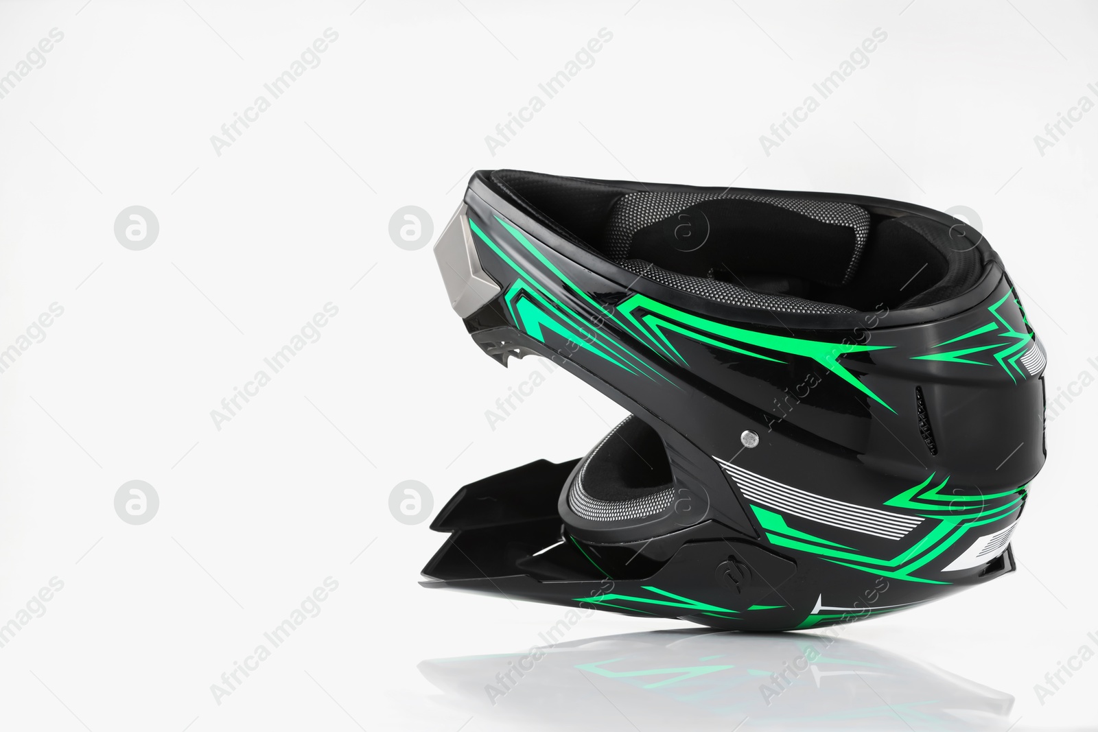 Photo of New stylish motorcycle helmet on white background, space for text