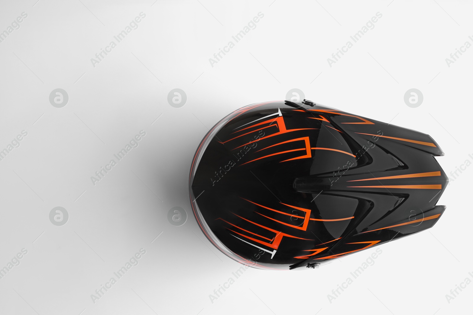 Photo of Stylish motorcycle helmet on white background, top view. Space for text