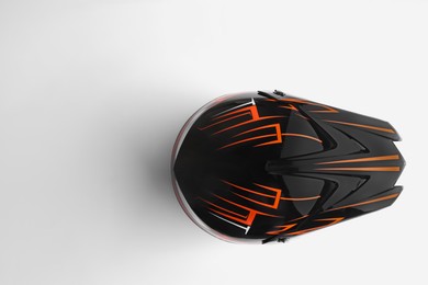 Photo of Stylish motorcycle helmet on white background, top view. Space for text