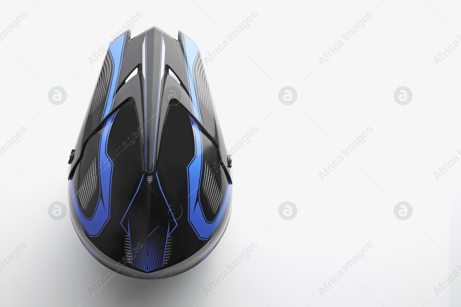 Photo of Stylish motorcycle helmet on white background, top view. Space for text