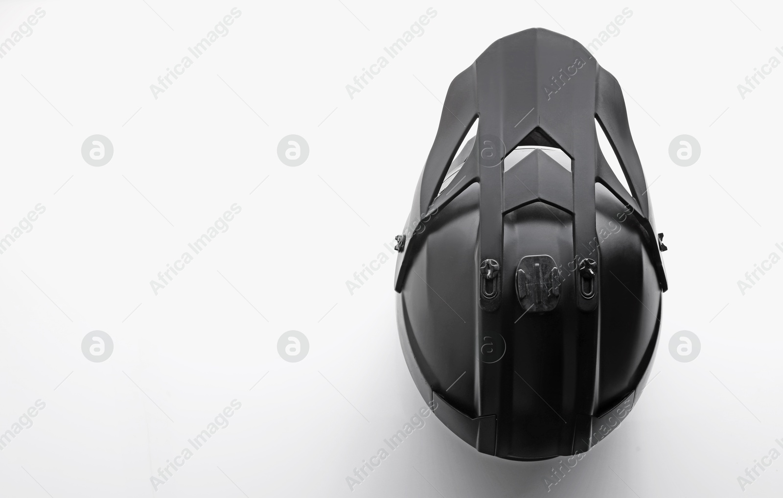 Photo of Stylish motorcycle helmet on white background, top view. Space for text