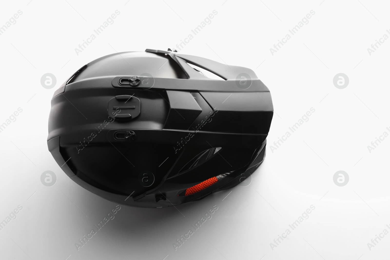 Photo of New stylish motorcycle helmet on white background, top view