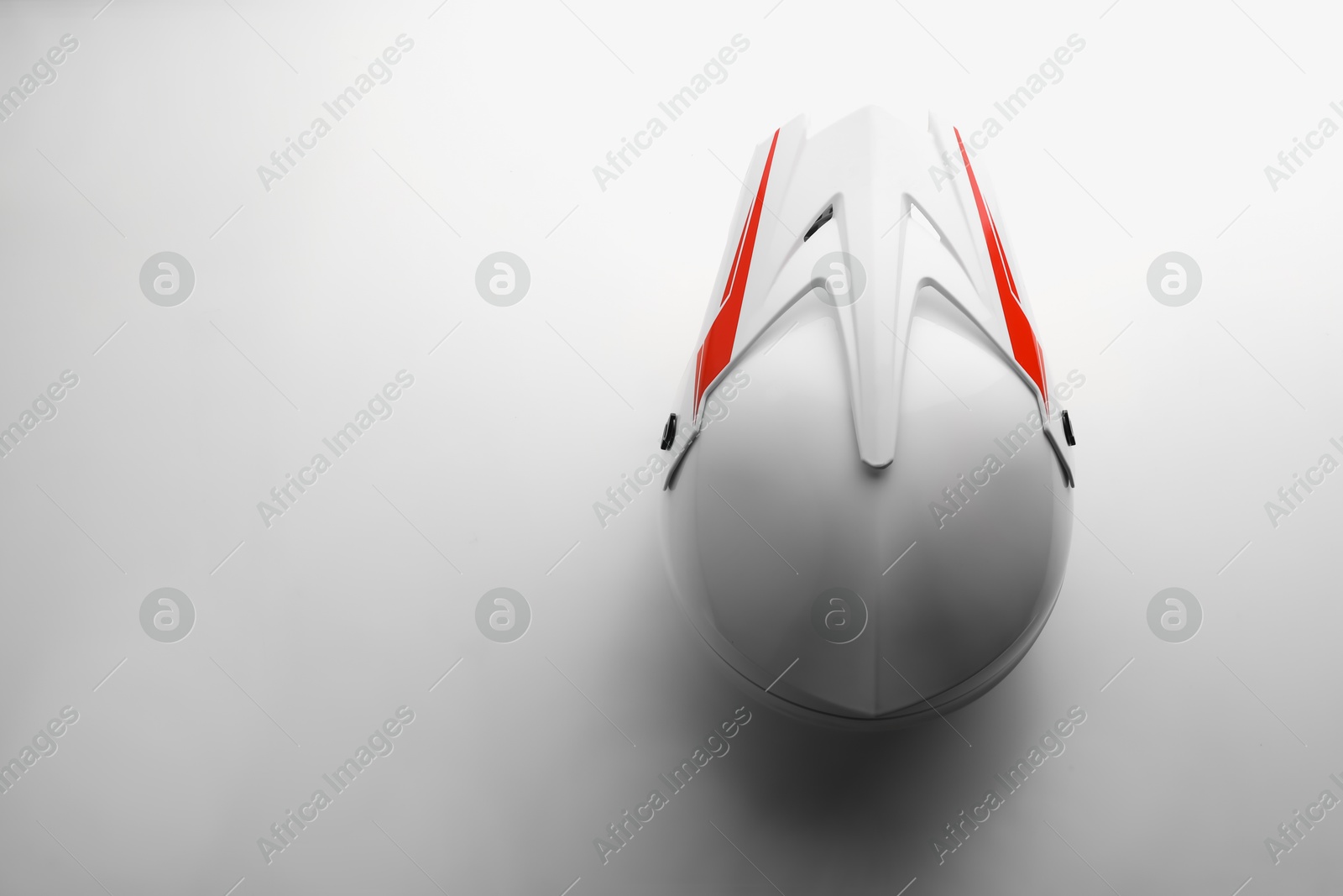 Photo of Stylish motorcycle helmet on white background, top view. Space for text