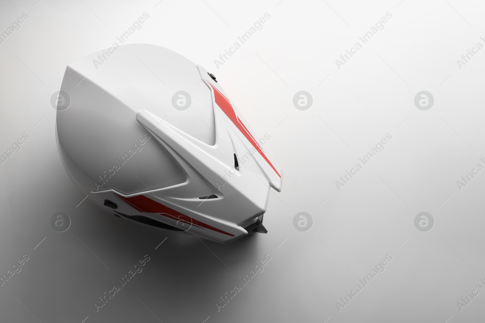 Photo of Stylish motorcycle helmet on white background, top view. Space for text