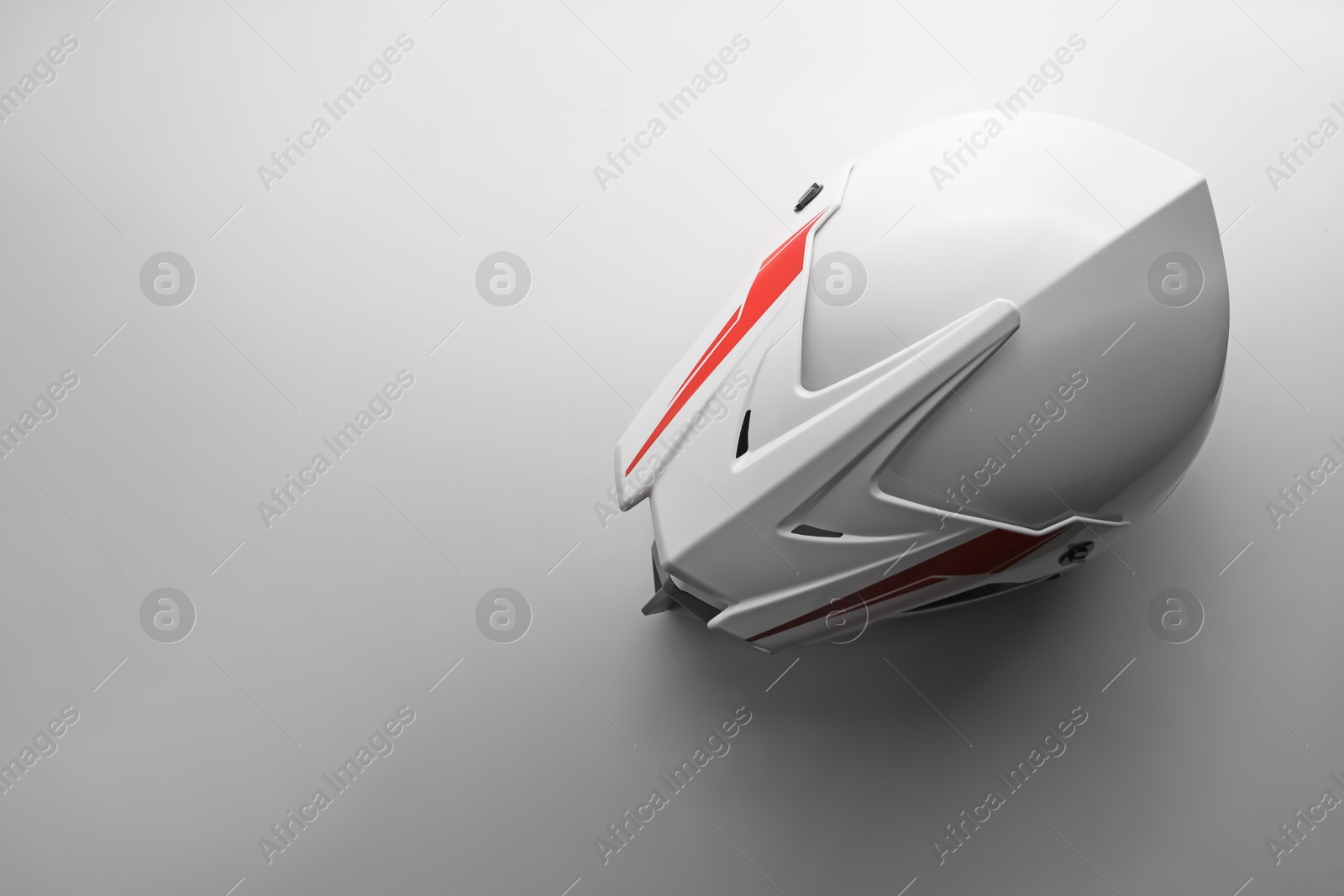 Photo of Stylish motorcycle helmet on white background, top view. Space for text