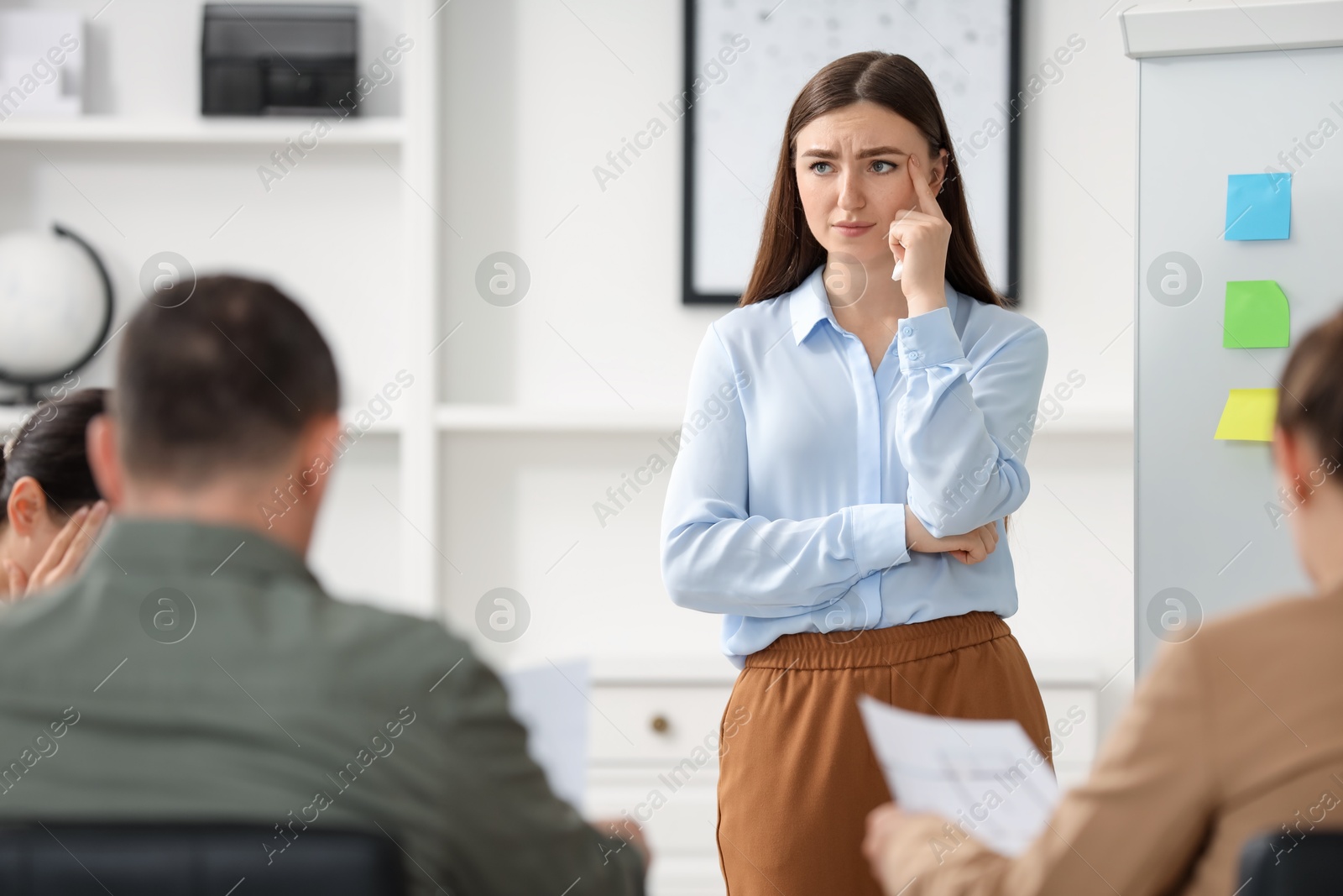 Photo of Woman feeling embarrassed during business meeting in office