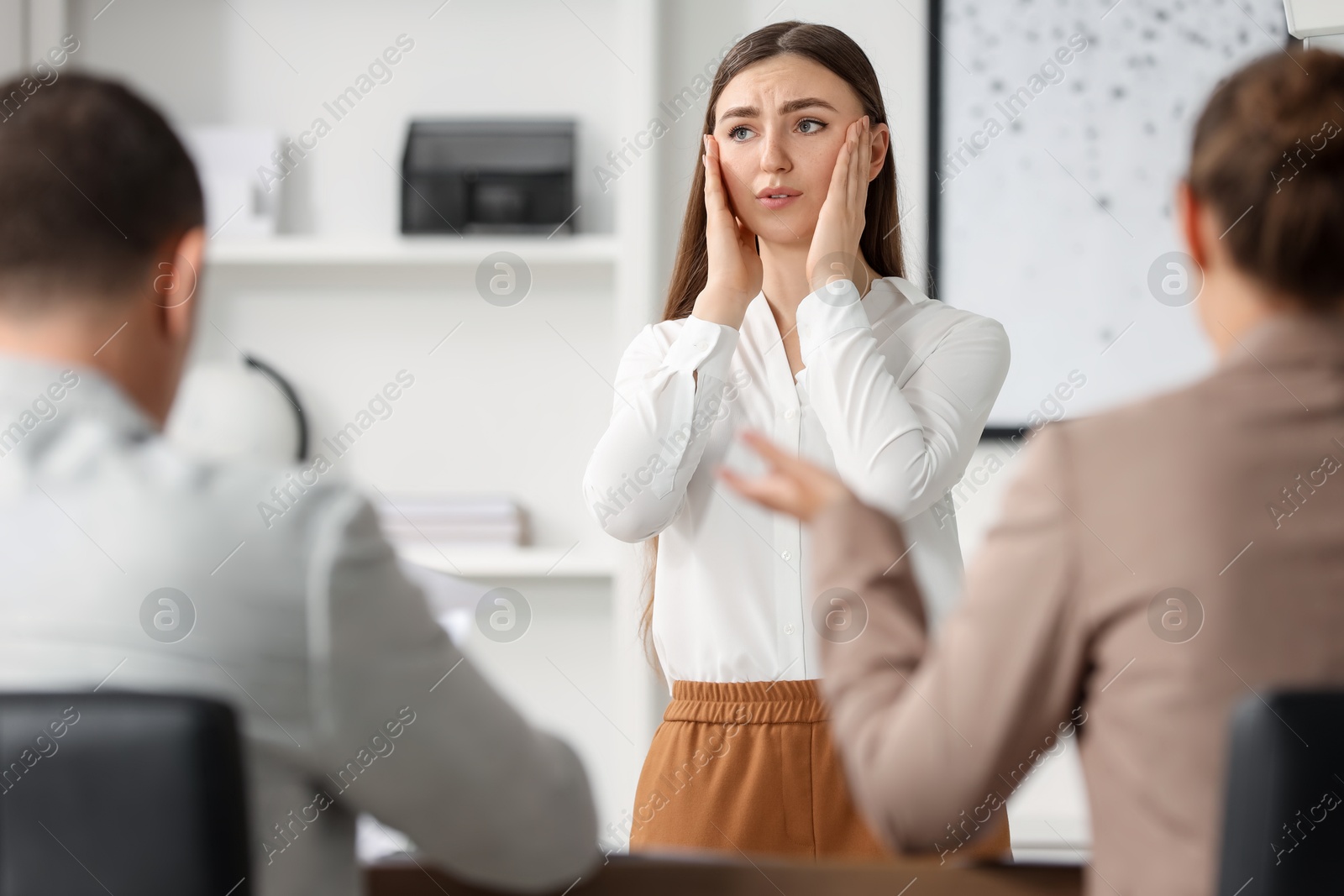 Photo of Woman feeling embarrassed during business meeting in office