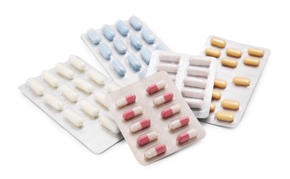 Photo of Different antibiotic pills in blisters isolated on white