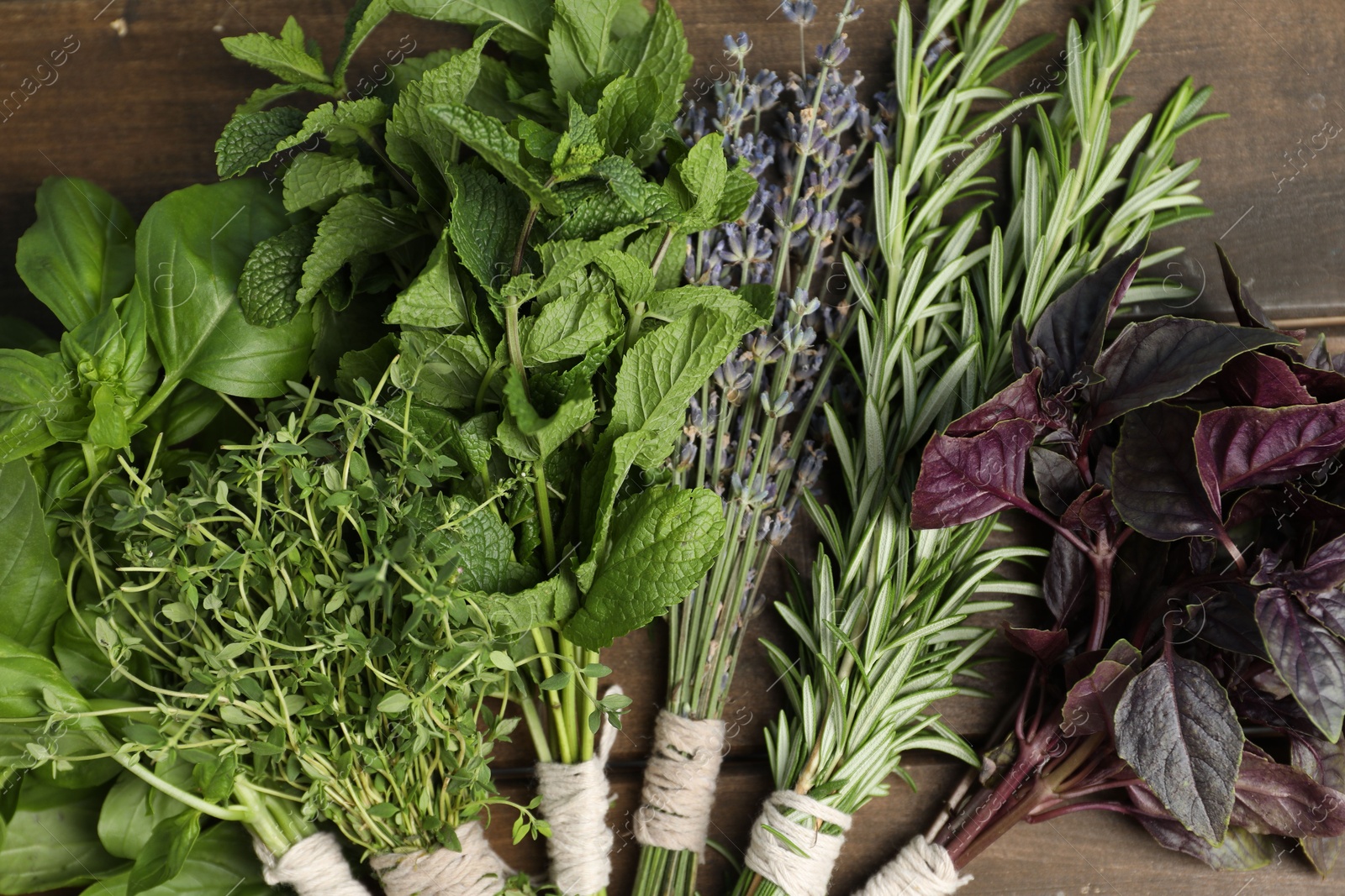 Photo of Different aromatic herbs on wooden table, top view