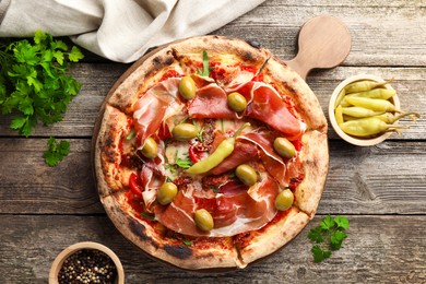 Photo of Tasty pizza and ingredients on wooden table, top view