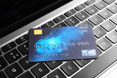 Photo of One plastic credit card on modern laptop