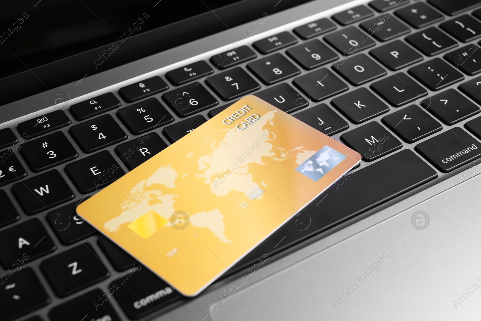 Photo of One plastic credit card on modern laptop