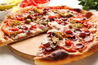 Photo of Delicious pizza Diablo on white textured table, closeup