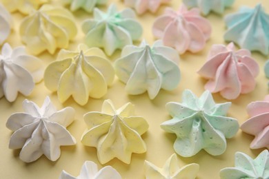 Photo of Delicious meringue cookies on beige background, closeup