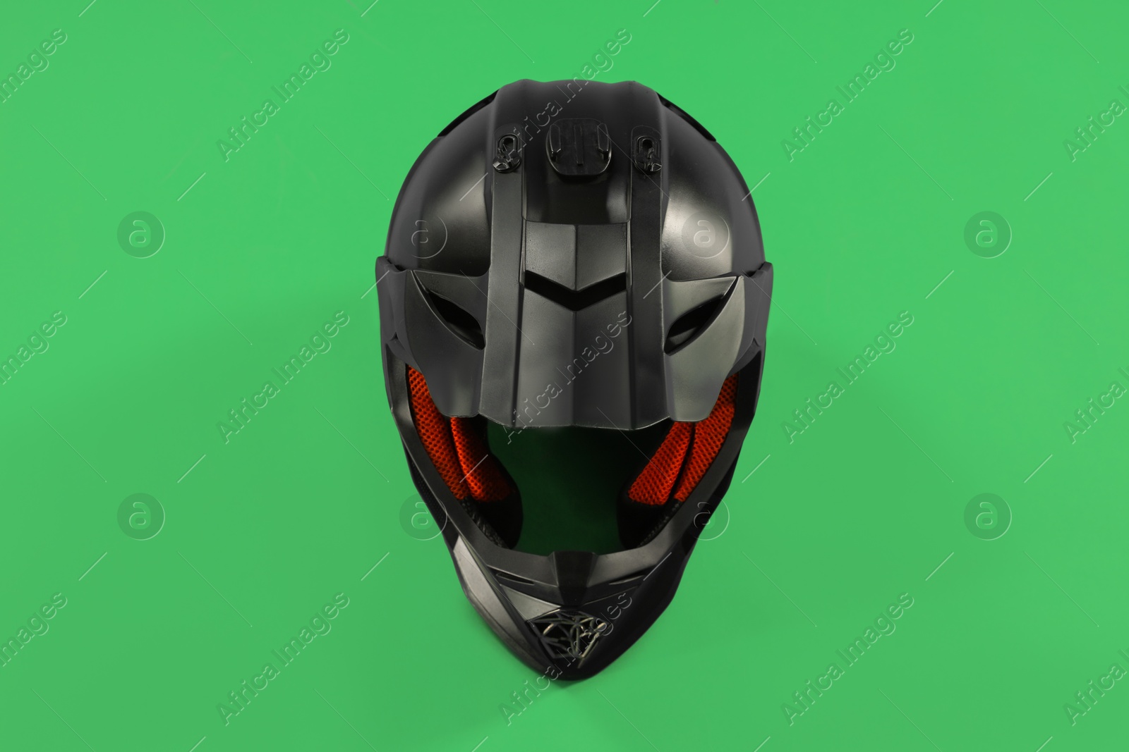 Photo of Modern motorcycle helmet with visor on light green background, top view