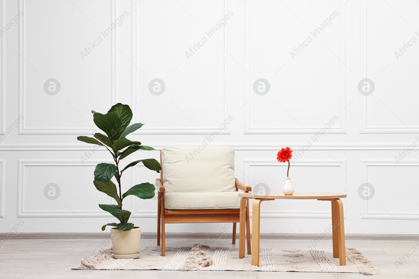 Photo of Beautiful interior with comfortable armchair and coffee table