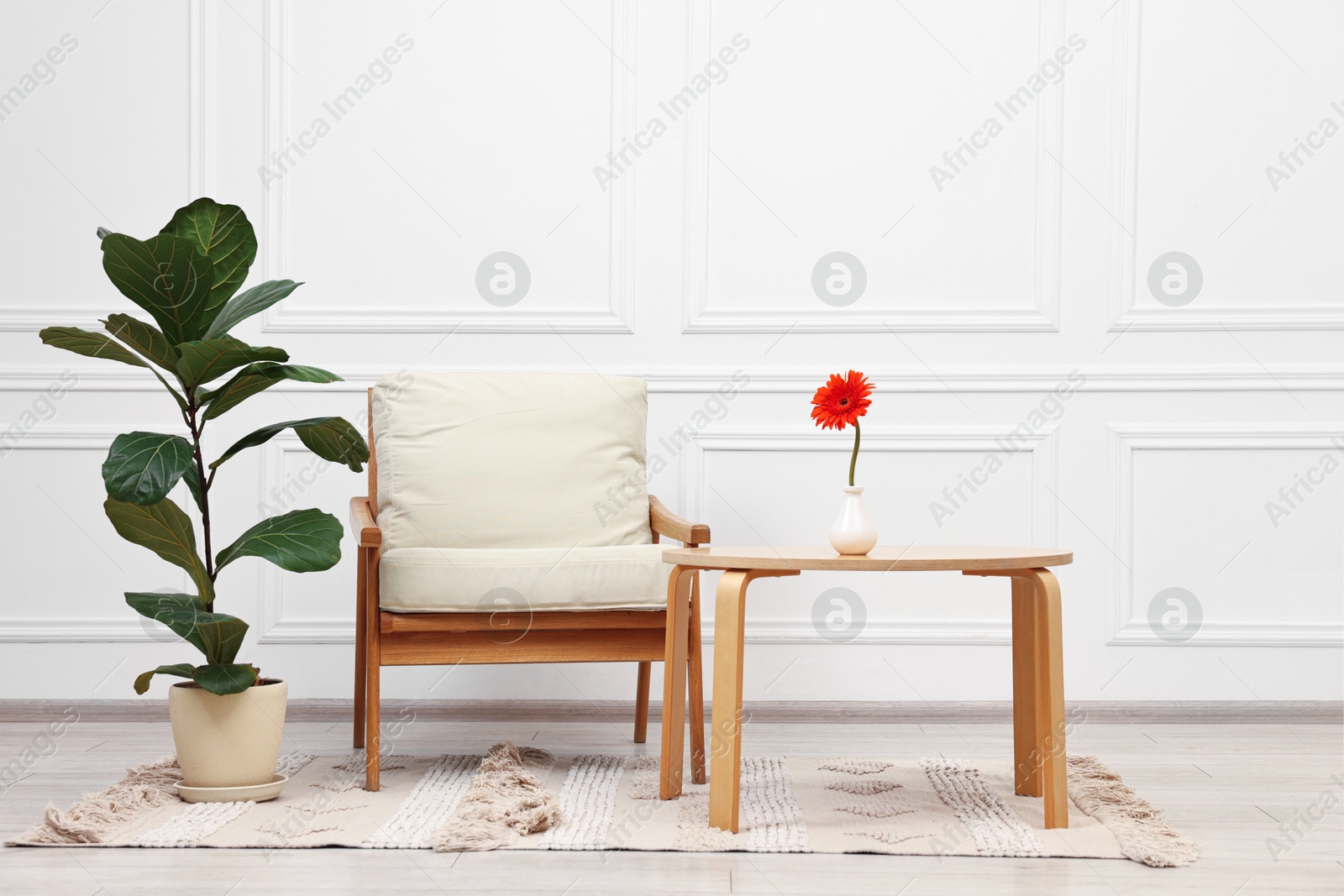 Photo of Beautiful interior with comfortable armchair and coffee table