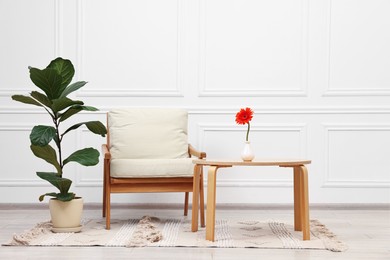 Photo of Beautiful interior with comfortable armchair and coffee table