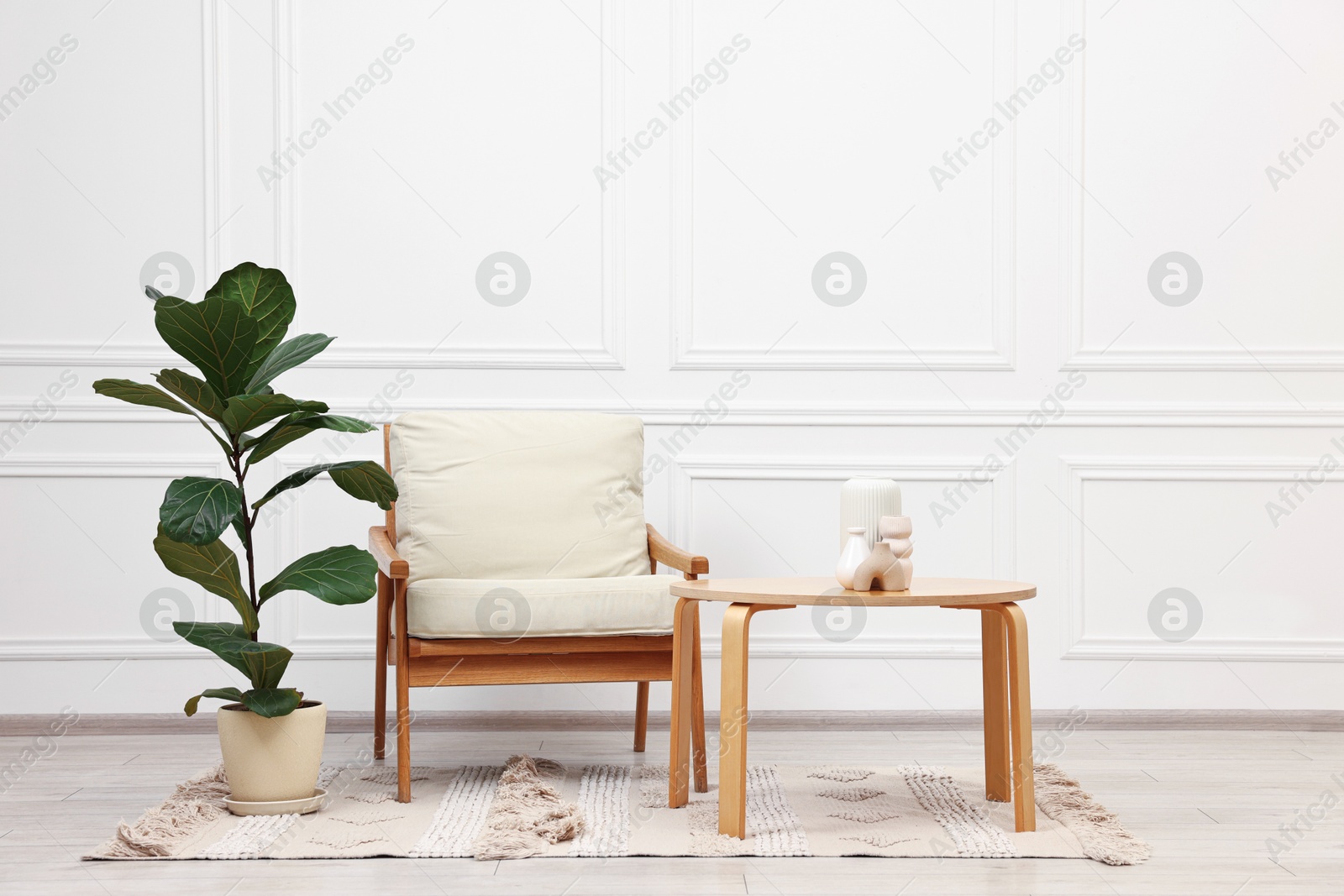 Photo of Beautiful interior with comfortable armchair and coffee table