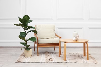 Beautiful interior with comfortable armchair and coffee table