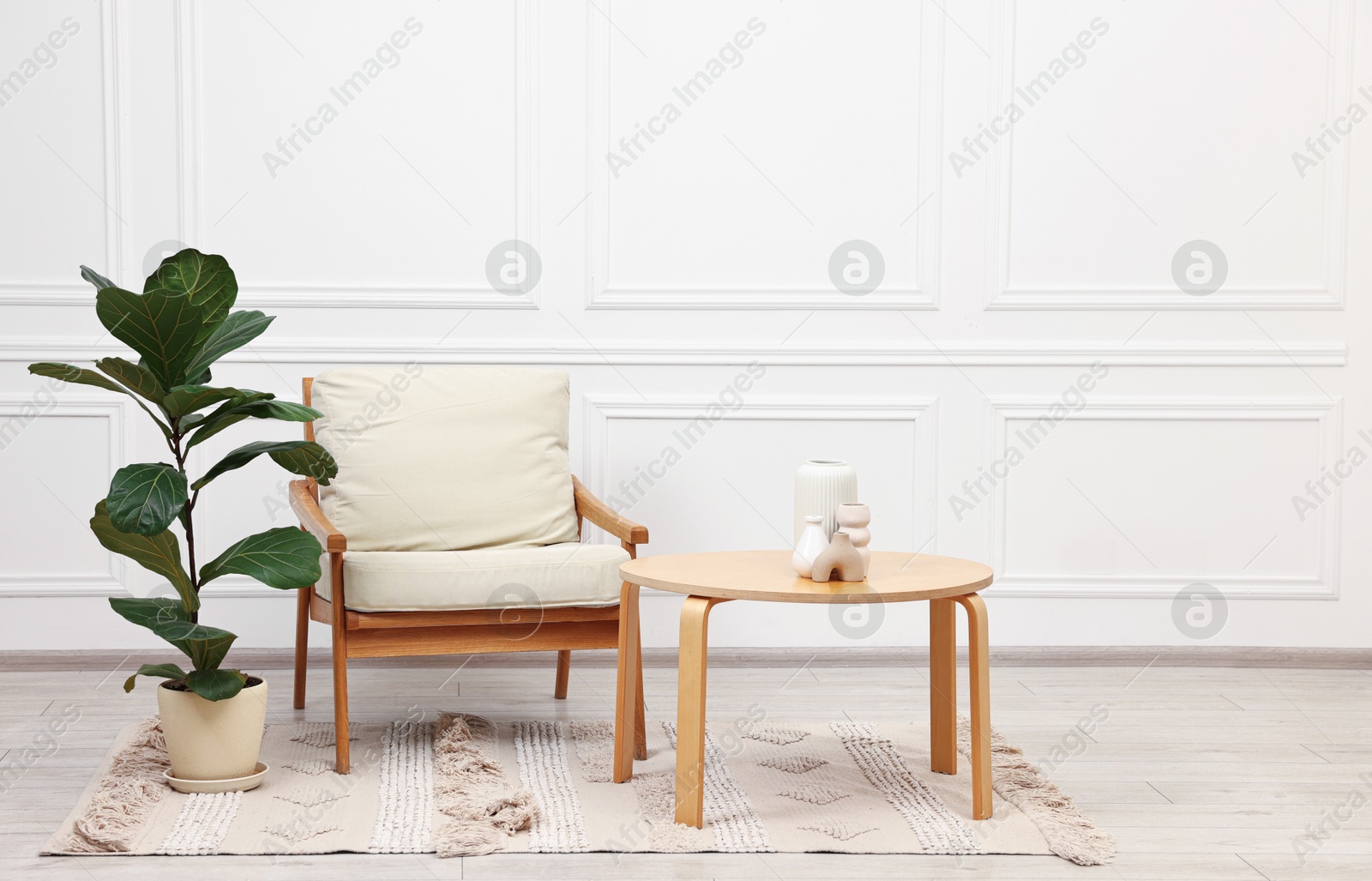 Photo of Beautiful interior with comfortable armchair and coffee table