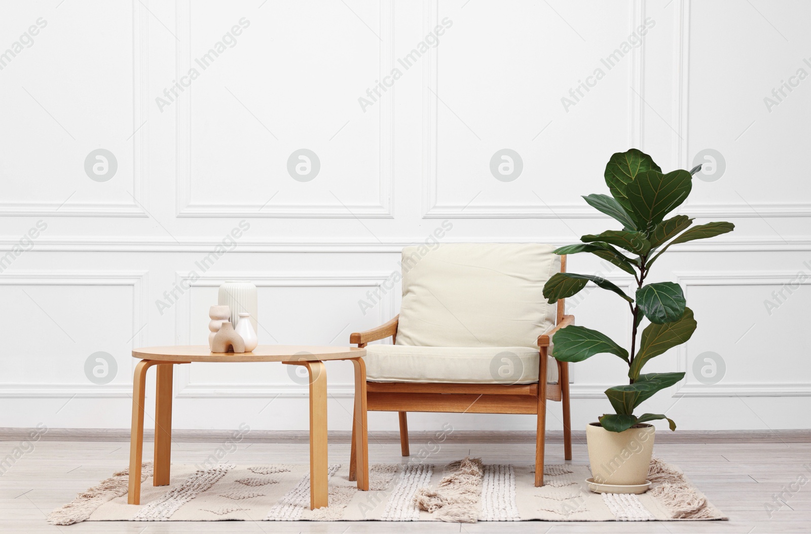 Photo of Beautiful interior with comfortable armchair and coffee table