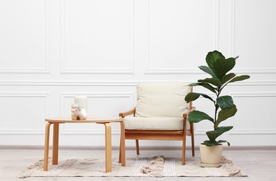 Beautiful interior with comfortable armchair and coffee table