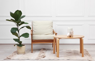 Photo of Beautiful interior with comfortable armchair and coffee table