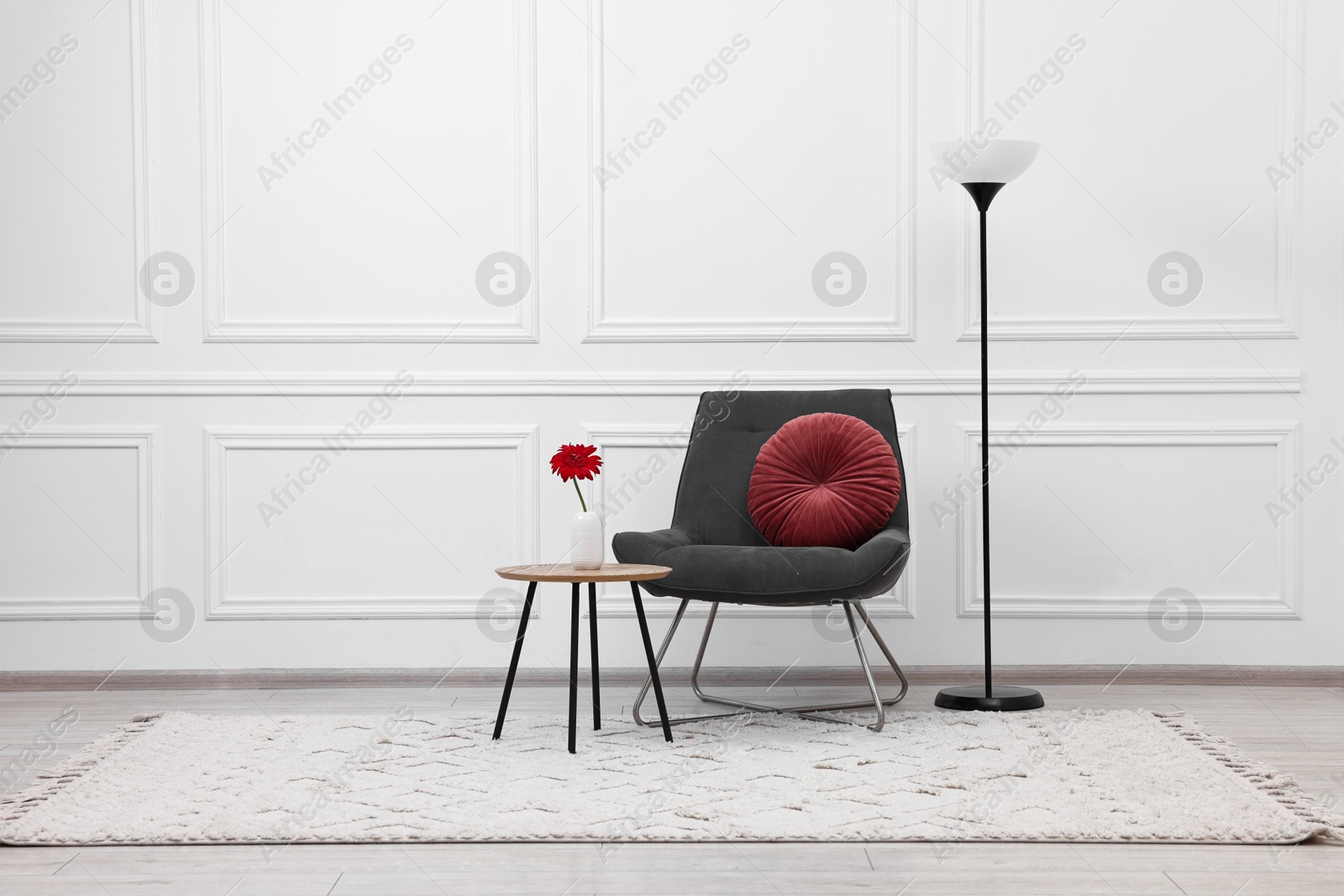 Photo of Beautiful interior with comfortable armchair and floor lamp