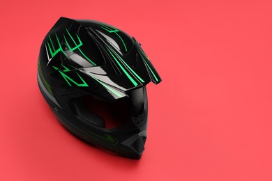 Modern motorcycle helmet with visor on red background. Space for text