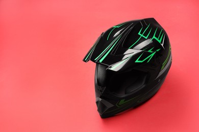 Modern motorcycle helmet with visor on red background. Space for text