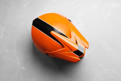 Photo of Modern motorcycle helmet with visor on light grey surface, top view
