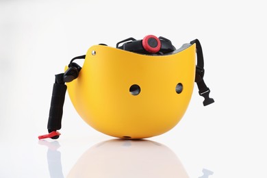 Photo of One yellow protective helmet on white background