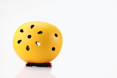 Photo of One yellow protective helmet on white background