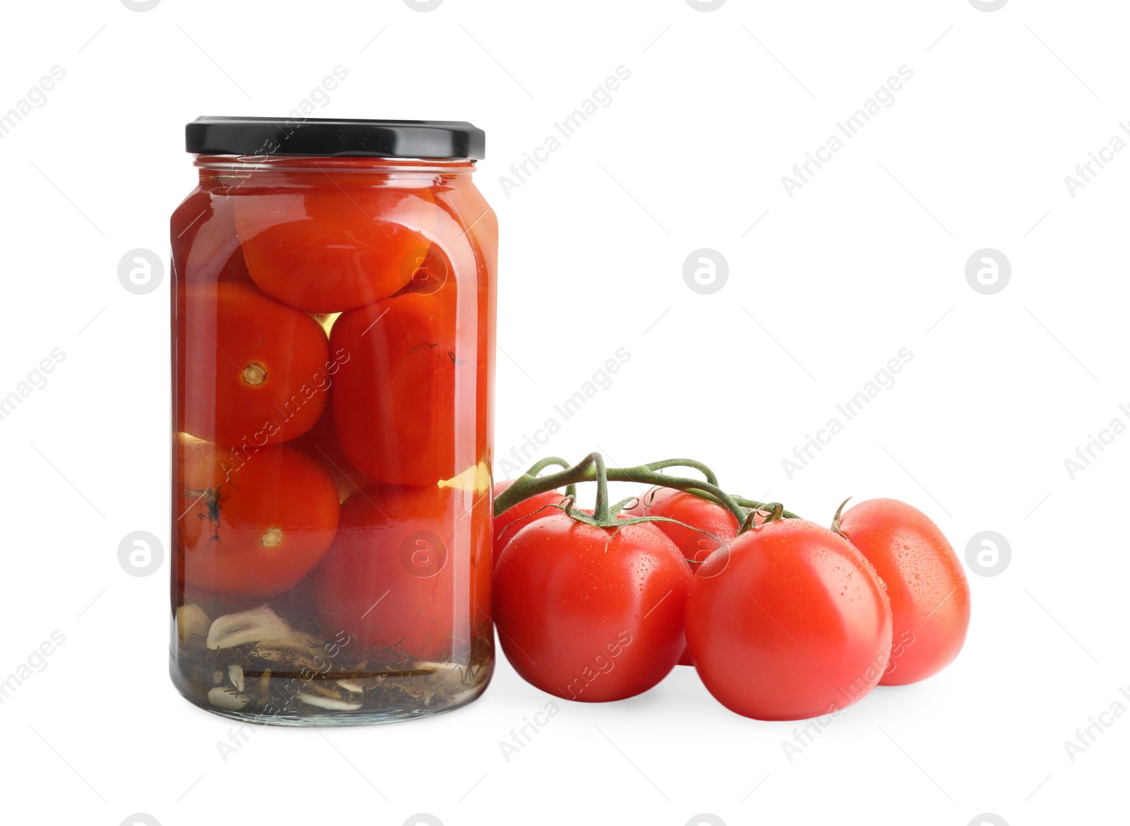 Photo of Tasty pickled tomatoes in jar and vegetable isolated on white