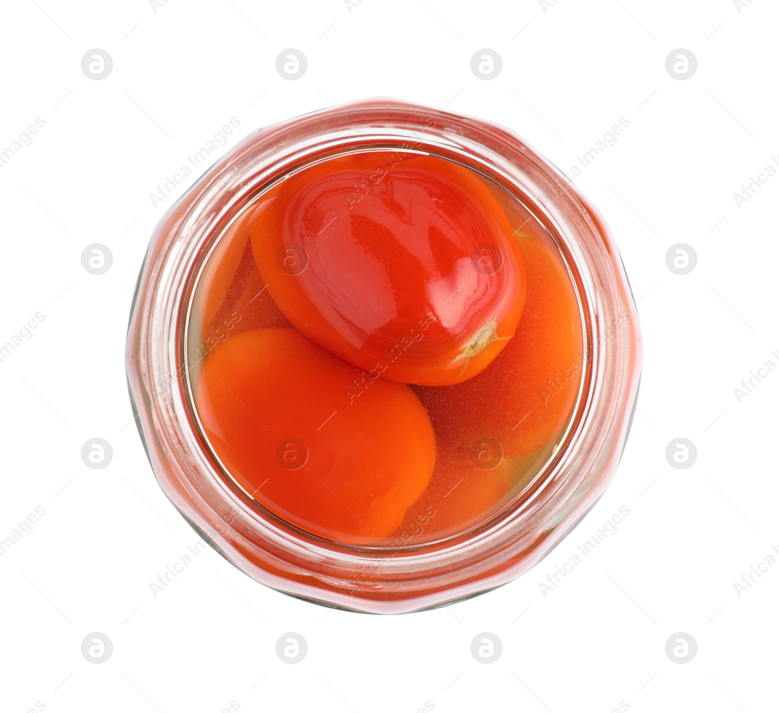 Photo of Tasty pickled tomatoes in jar isolated on white, top view