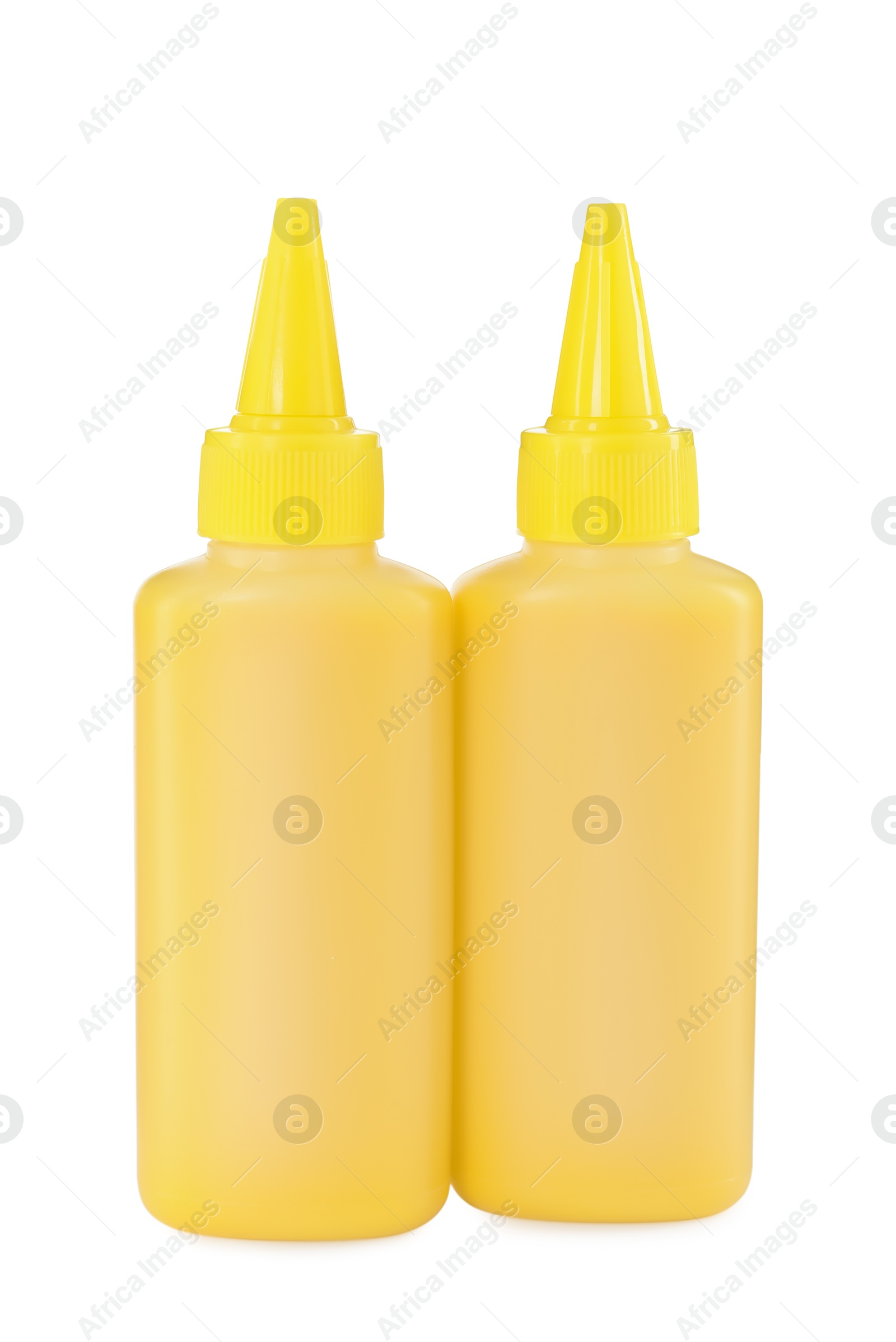 Photo of Bottles of yellow printer ink isolated on white