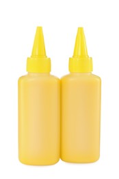 Photo of Bottles of yellow printer ink isolated on white