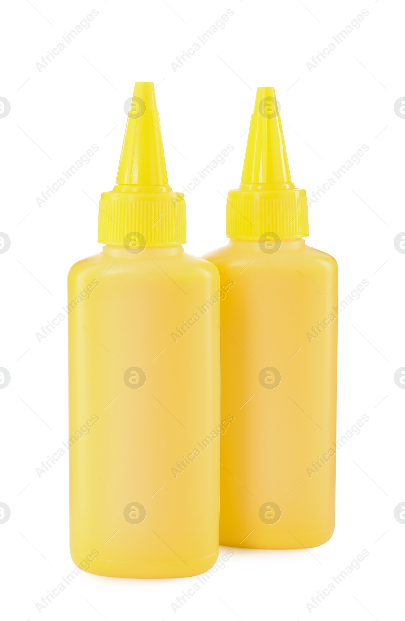 Photo of Bottles of yellow printer ink isolated on white